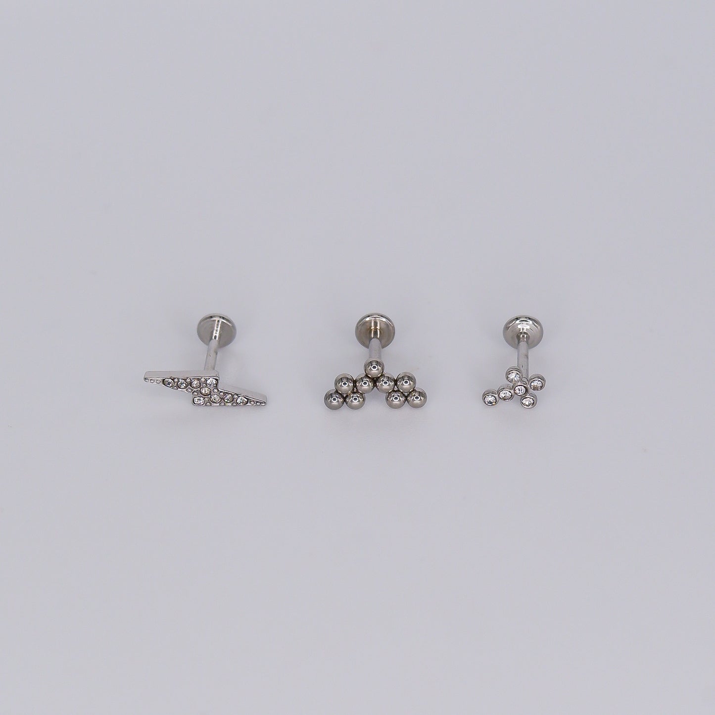 Piercing Achatado Raio, Bolas e Cruz